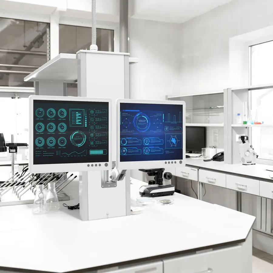 Two monitors on ceiling-mounted arms in a laboratory